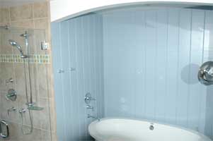 Farm-style soaking tub with wood surround